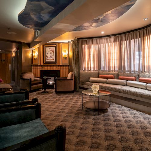 A luxurious lounge with plush seating, warm lighting, and a curved windowed wall, perfect for relaxing in style.