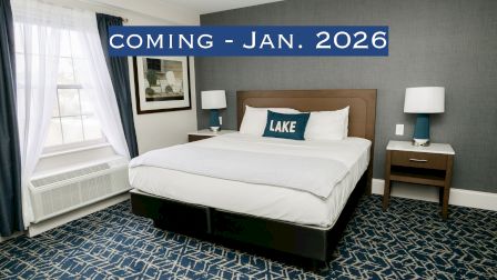 A modern bedroom with a bed, side tables, lamps, and a "COMING - JAN. 2026" banner across the image.
