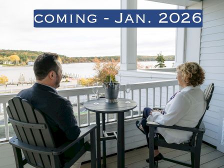Two people sit on a porch overlooking a scenic view. Text above reads: "COMING - JAN. 2026".