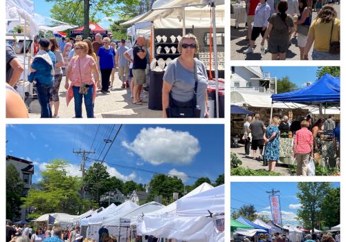 The image shows a busy outdoor market with people browsing various stalls under white tents on a sunny day.