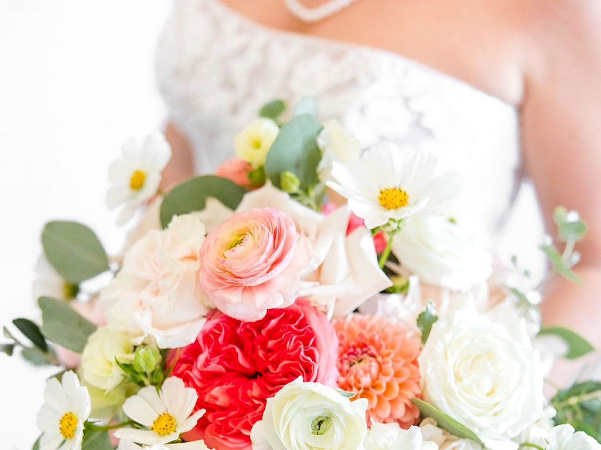 A bridal bouquet with pale roses, pink and white blooms, daisies, and greenery&mdash;beautiful, fresh, and ready for a wedding moment.