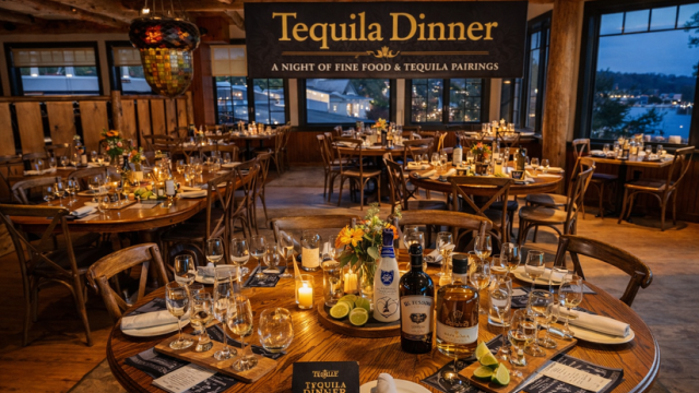 Elegant dinner setup in a rustic venue with wooden tables, wine bottles, candles, and a &ldquo;Tequila Dinner&rdquo; banner overhead, inviting fine dining tonight.